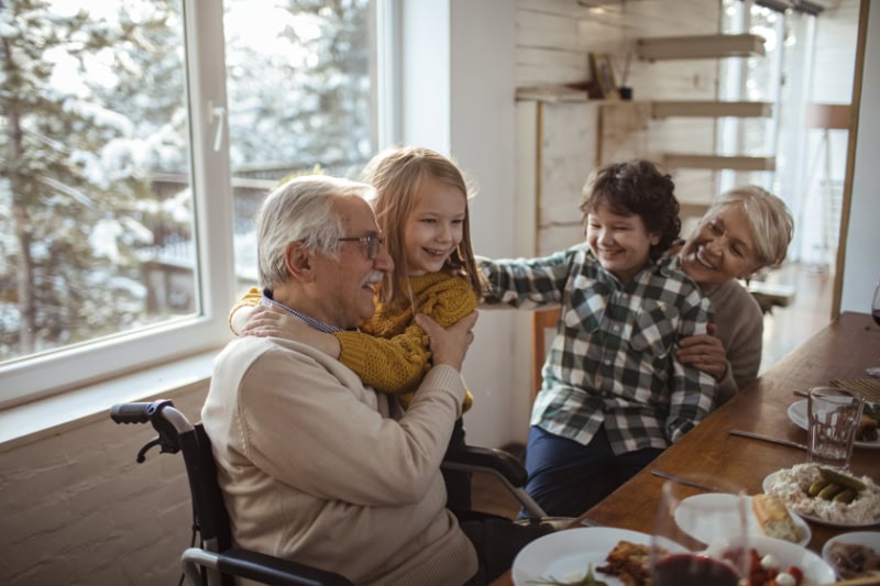 Happy multi-generational family enjoying a meal together in a cozy home