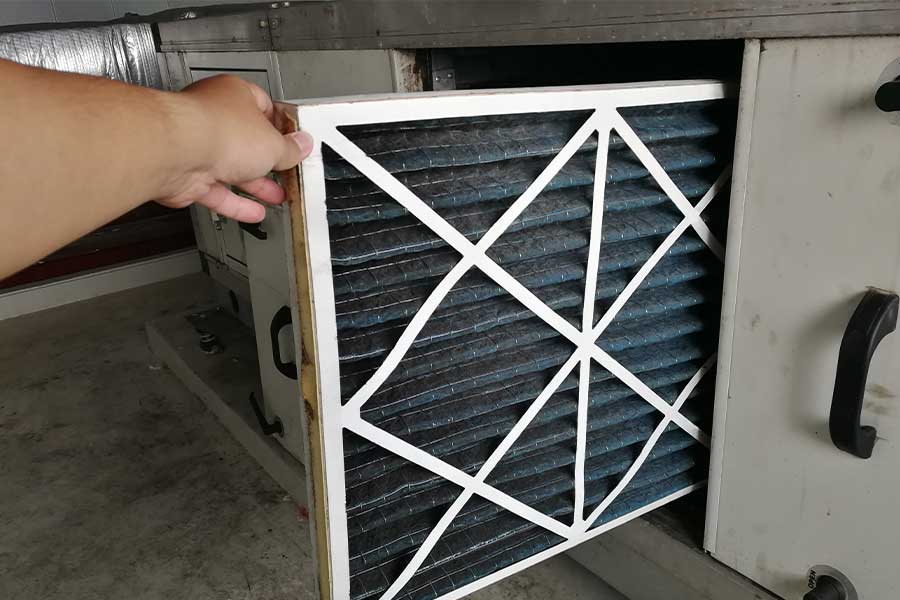 Person replacing a dirty HVAC air filter