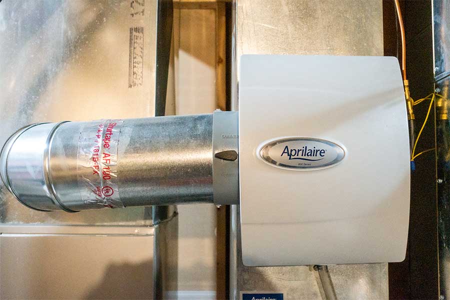 Aprilaire whole-home humidifier installed on an HVAC duct.