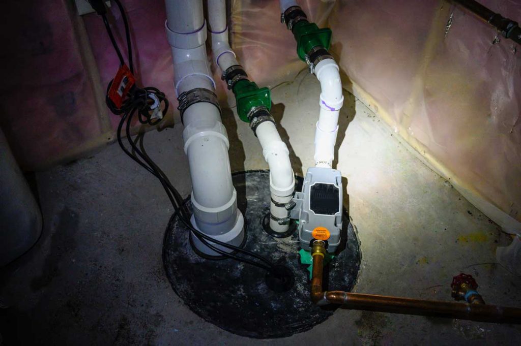 Piping and electrical connections for a sump pump