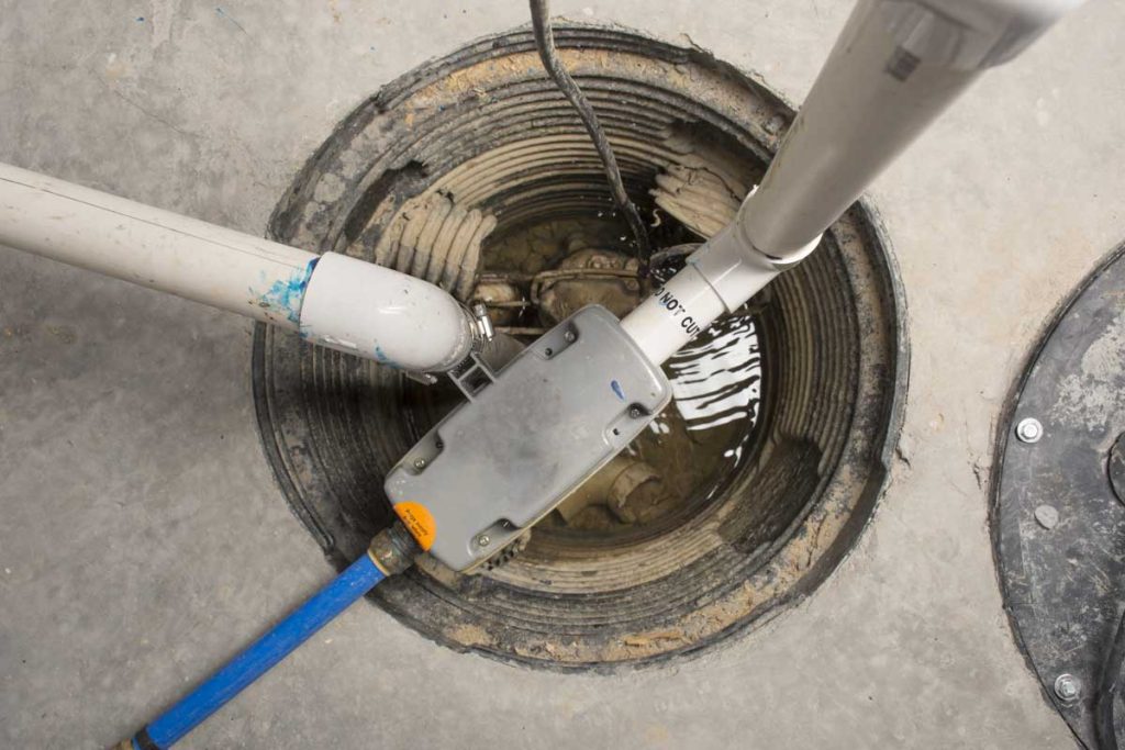 Basement sump pit with connected drainage pipes