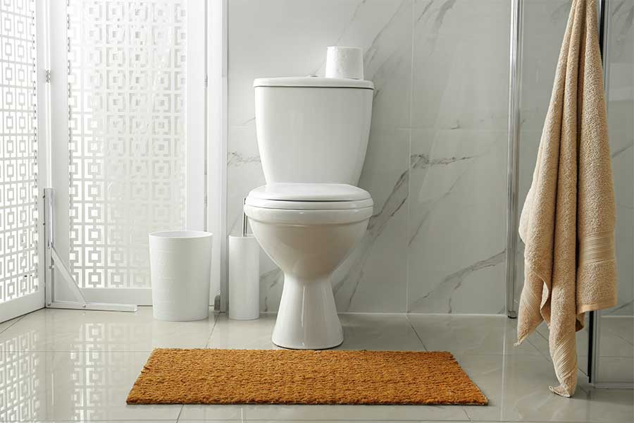 Clean and elegant toilet with marble walls