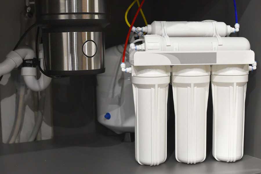 Multi-stage water filter system connected to plumbing under a sink