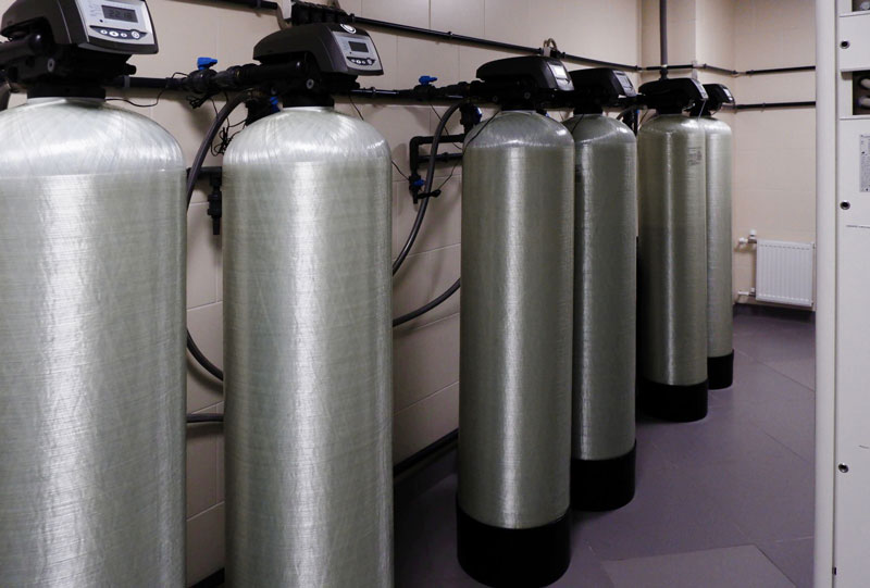 Row of water softener tanks in a commercial facility