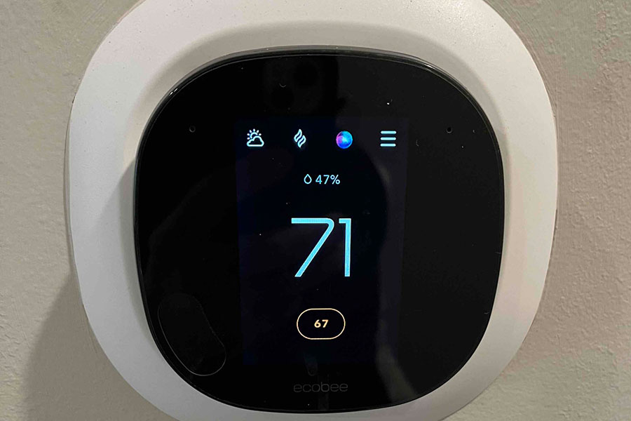 Smart thermostat displaying 71°F